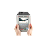 A handheld diagnostic tool device with a built-in screen and keyboard, being held by two hands against a plain white background. The device has a gray and black body with a screen showing a live feed.