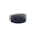 A dark gray electronic device with orange accents, featuring two terminal connectors labeled COM and (+) and a red power button, shown against a plain white background.